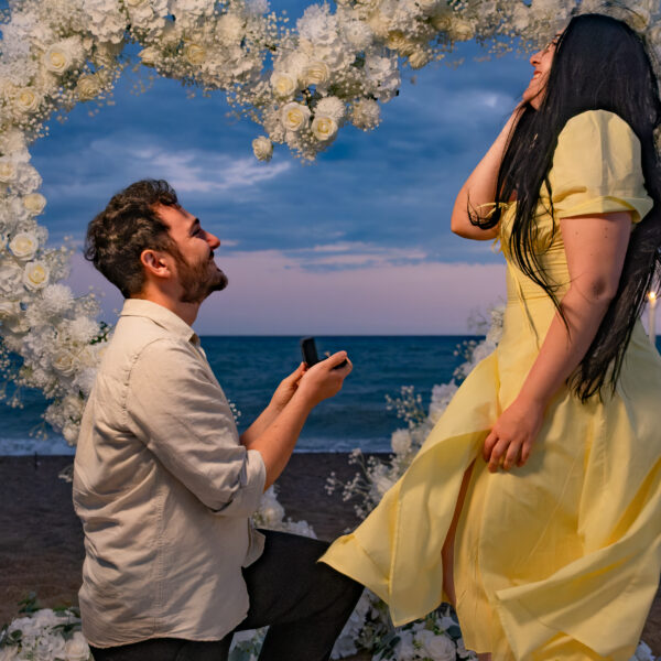 Couple photographed after a seaside proposal